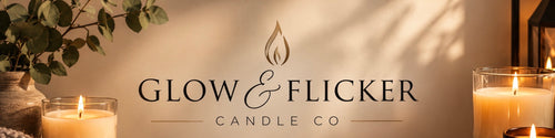 A warm-toned branded candle photo for Glow & Flicker Candle Co, with the company name centered on a beige wall, candle flames visible in glass holders at left and right, and soft leaf shadows across the background.
